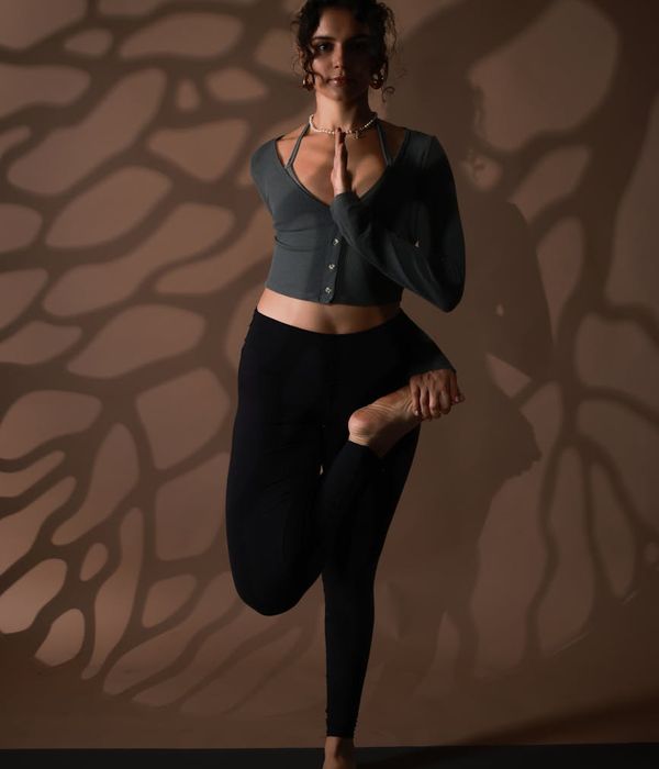 A woman in a serene yoga pose, embodying balance and calm.